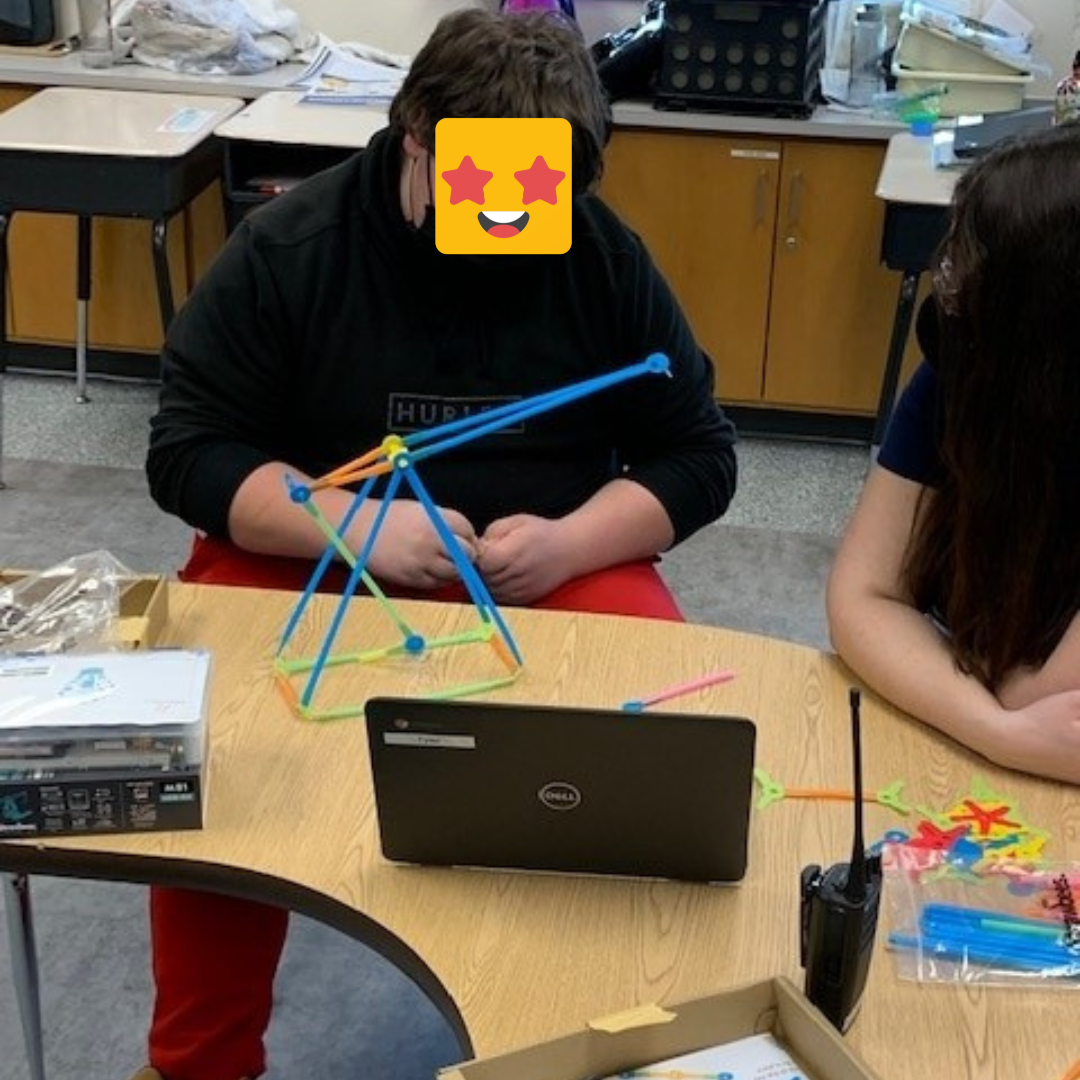 A student building a Strawbees Trebuchet.