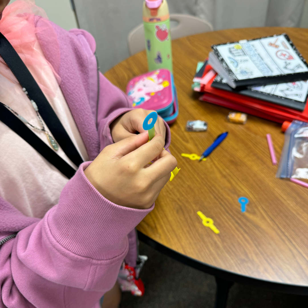 A student working with Strawbees.