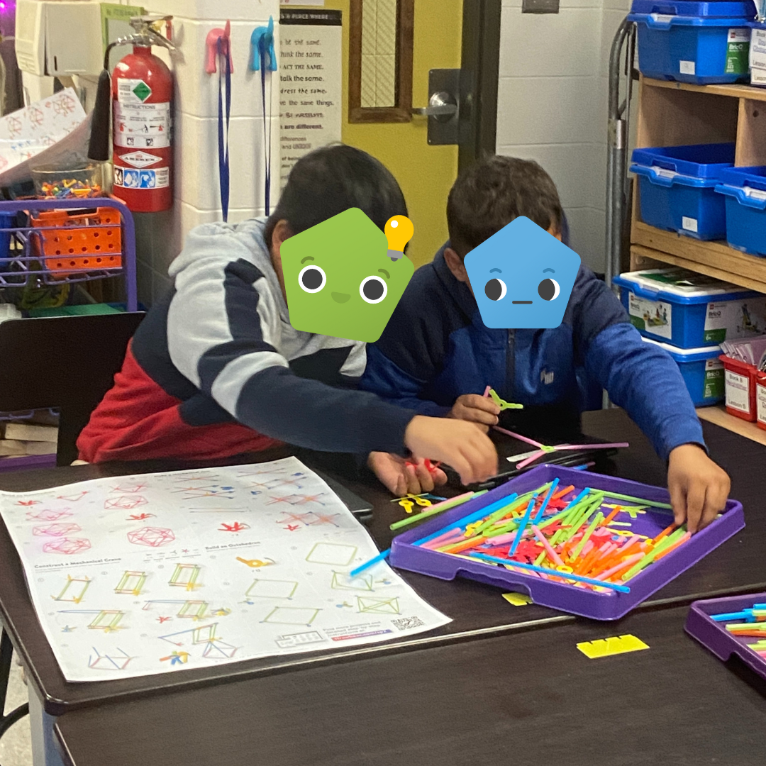 Two students building with Strawbees.