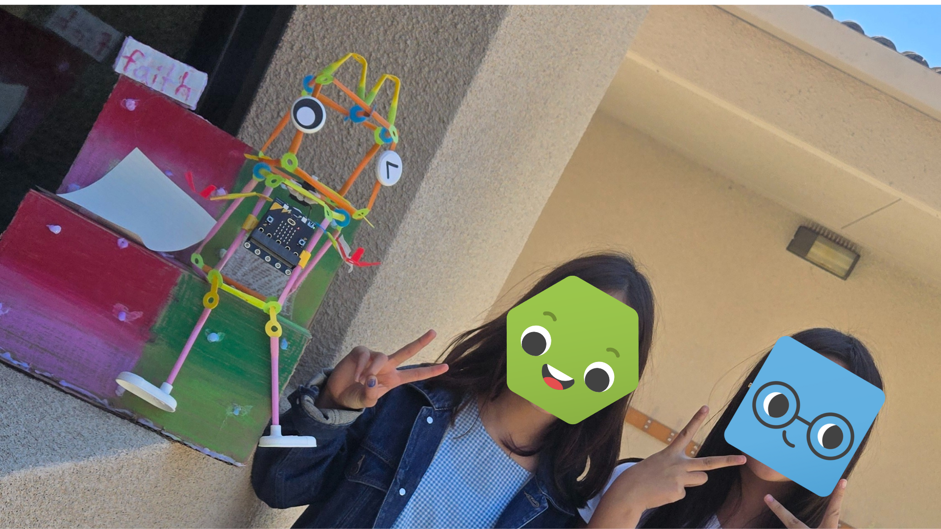 Two students showing off their Friendbot.