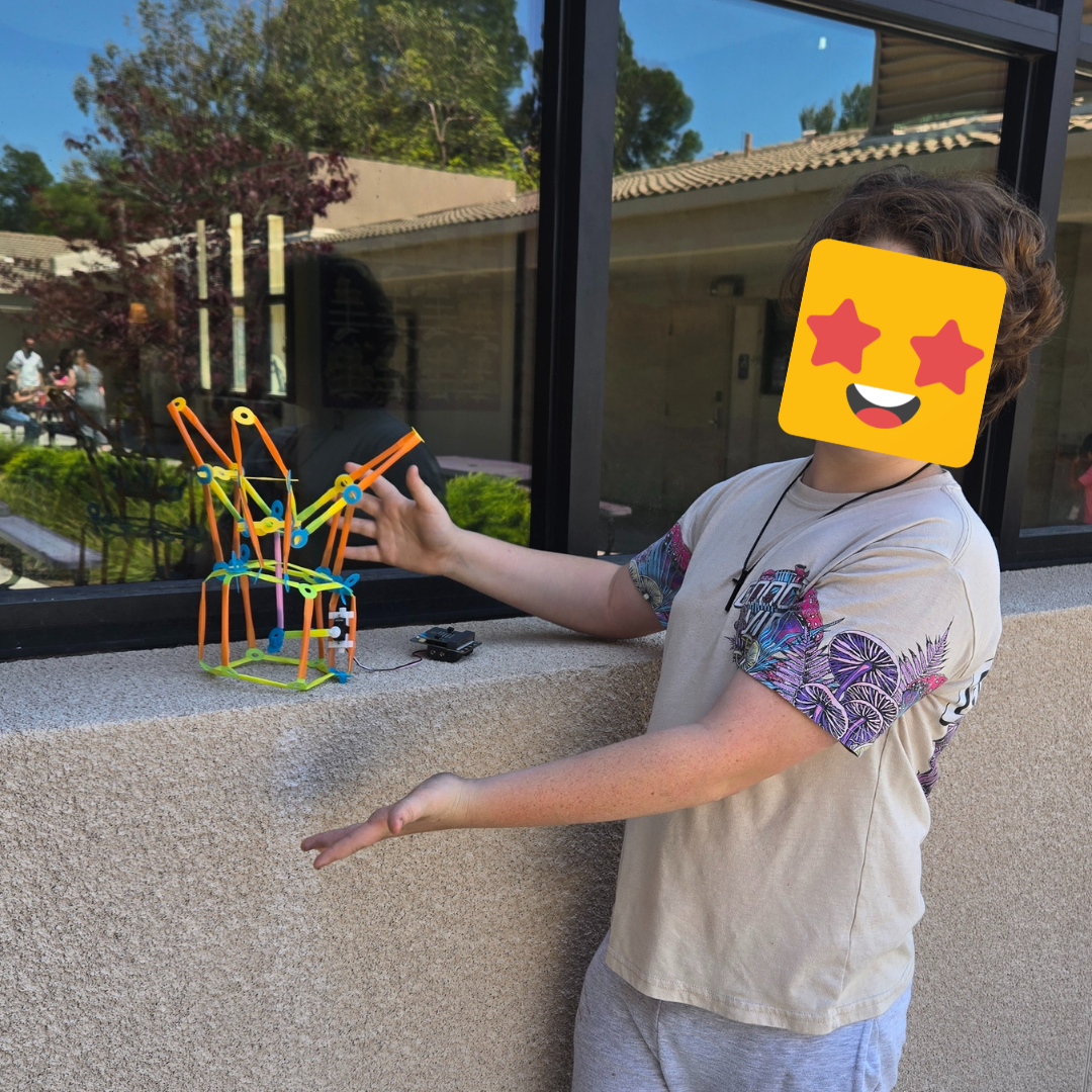 A student showing off their Strawbees build.
