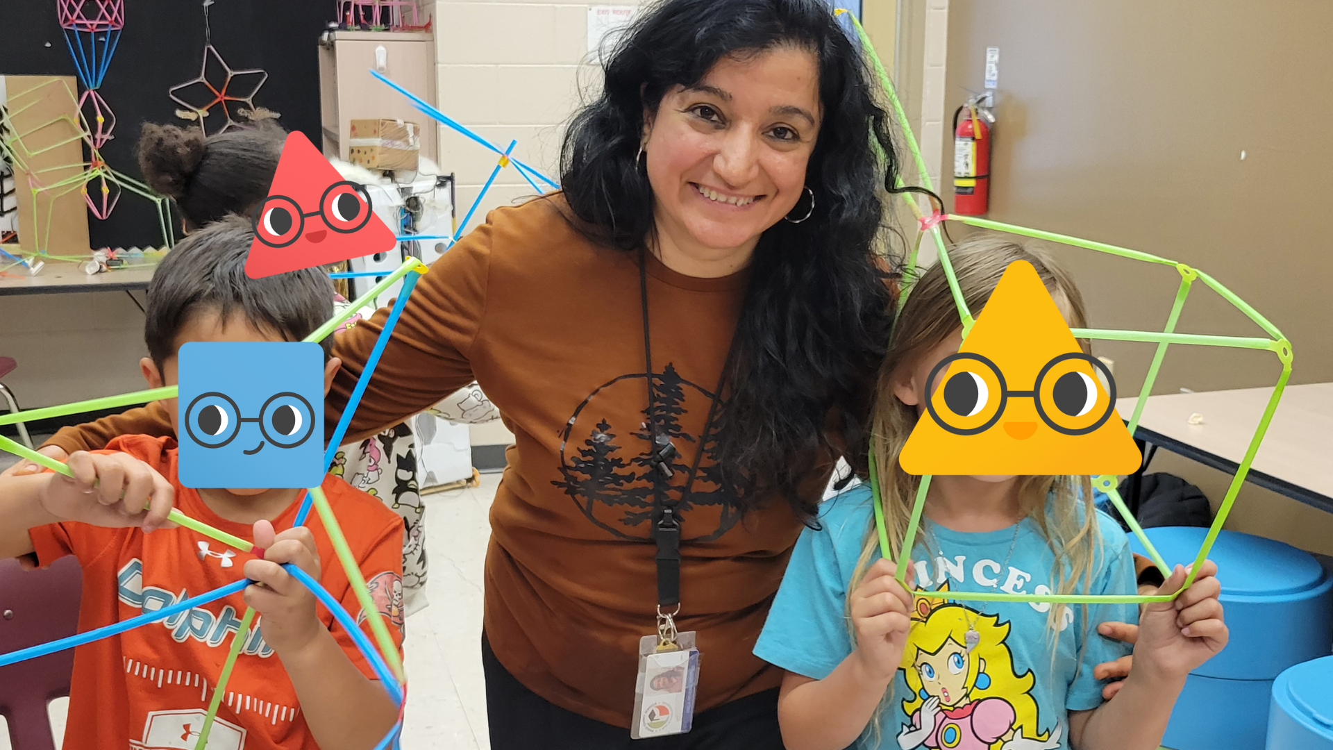 Hala with two student showing off their Strawbees.