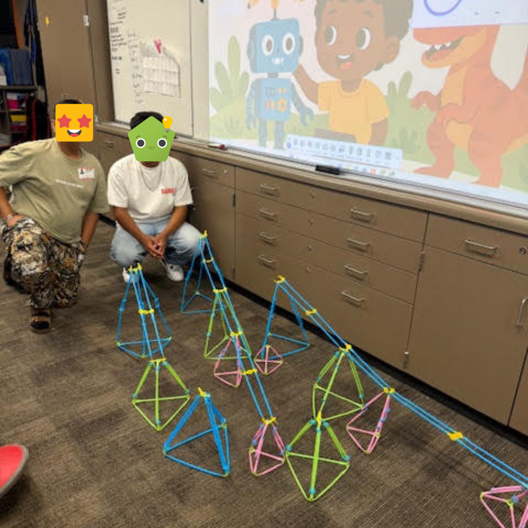 Two students presenting their build with Strawbees.