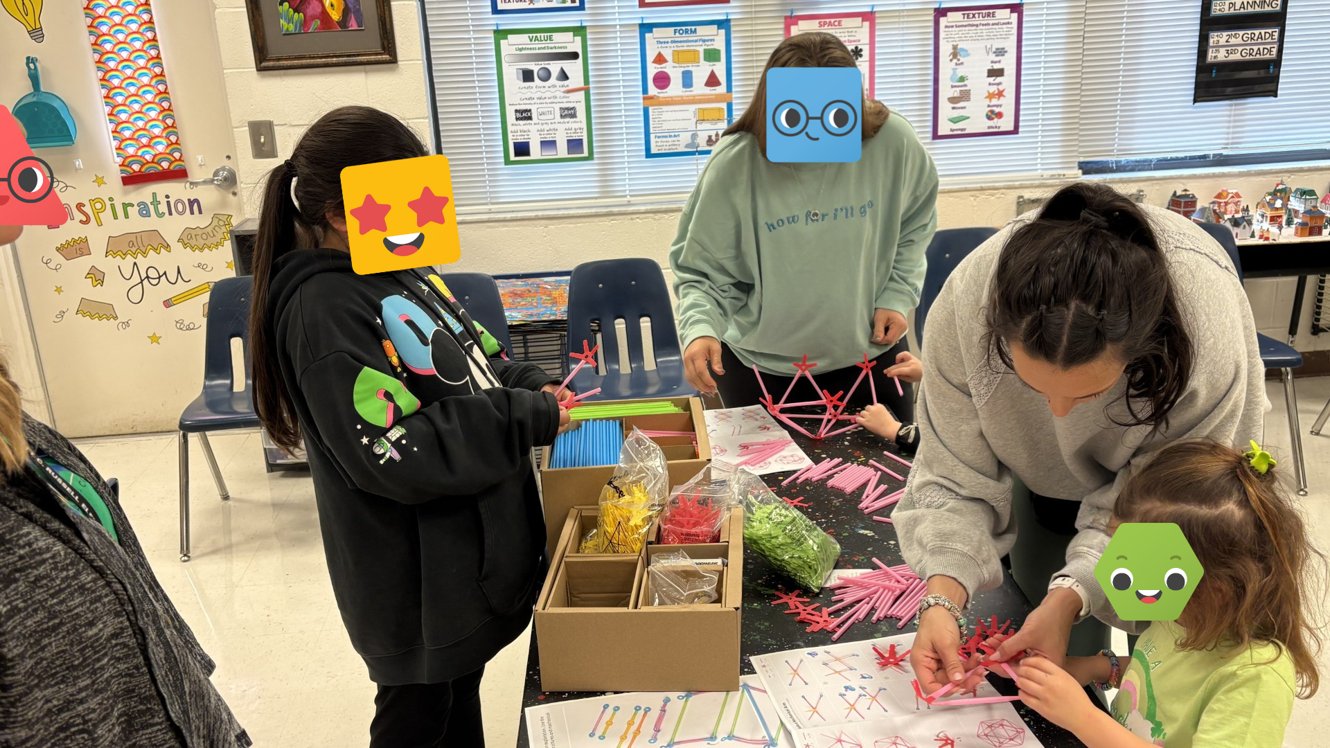A group of students building with Strawbees.