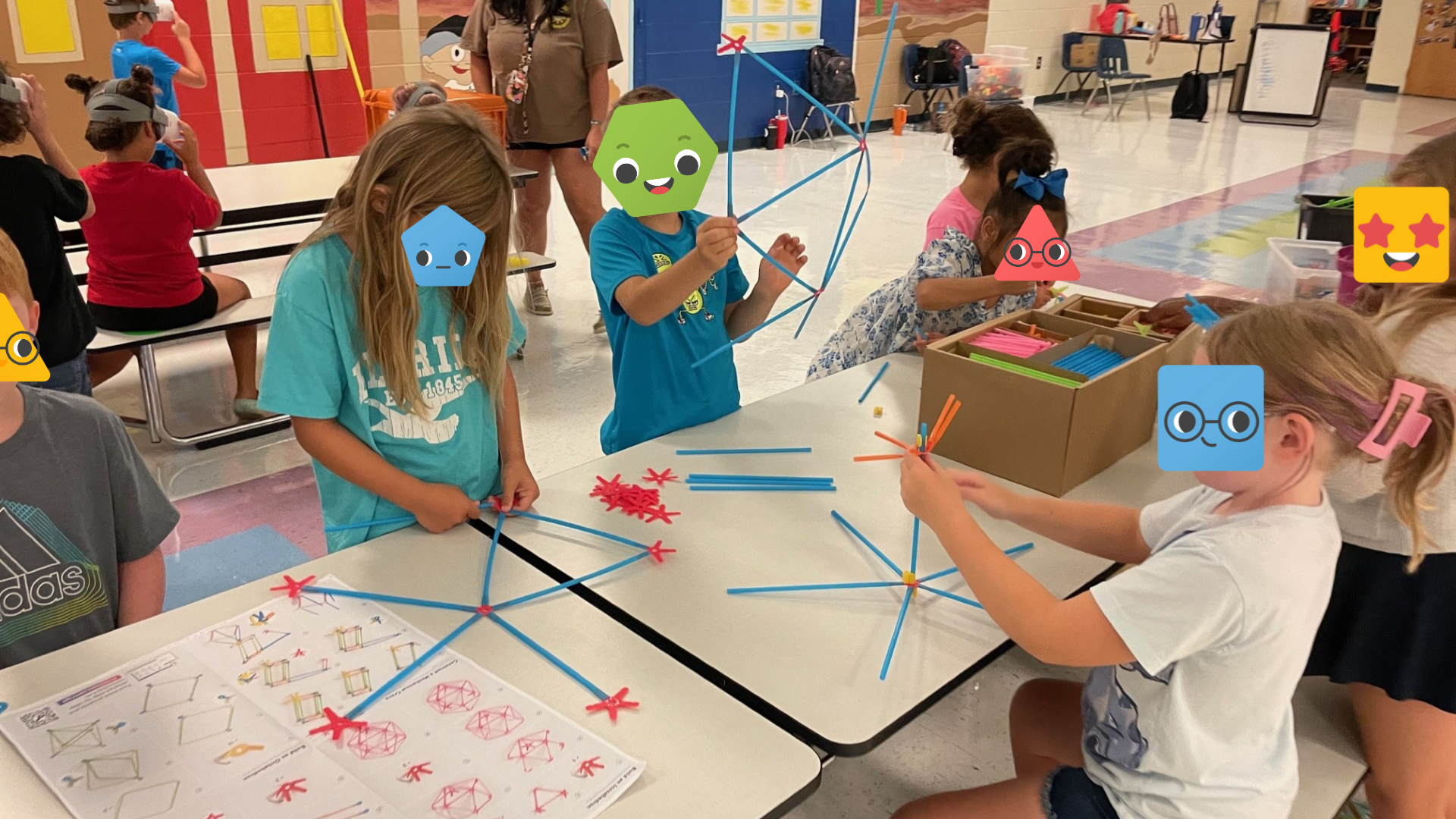 A group of students building with Strawbees.
