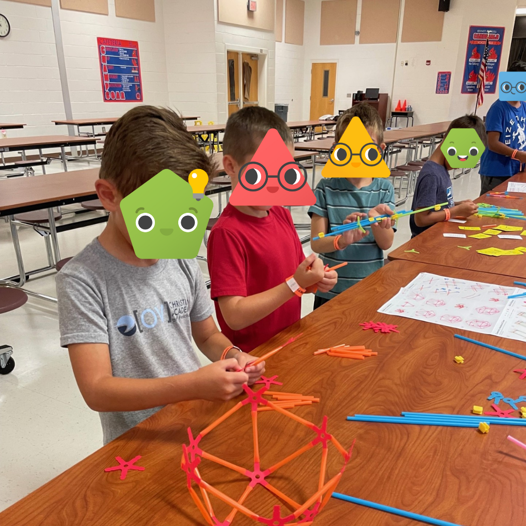 A group of students building with Strawbees.