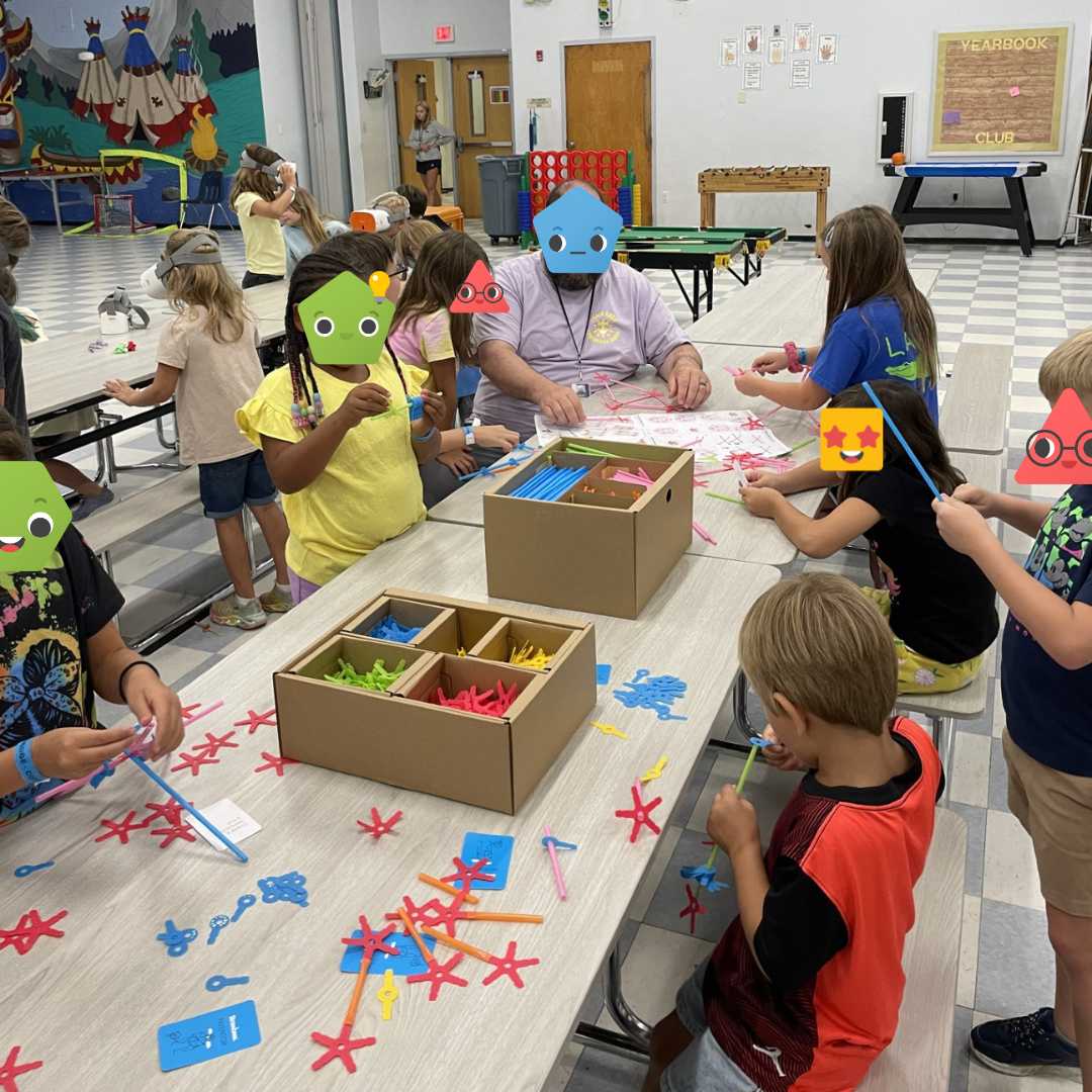 A group of students building with Strawbees.