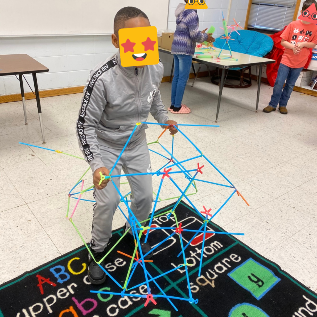 A student shows off their Strawbees build.