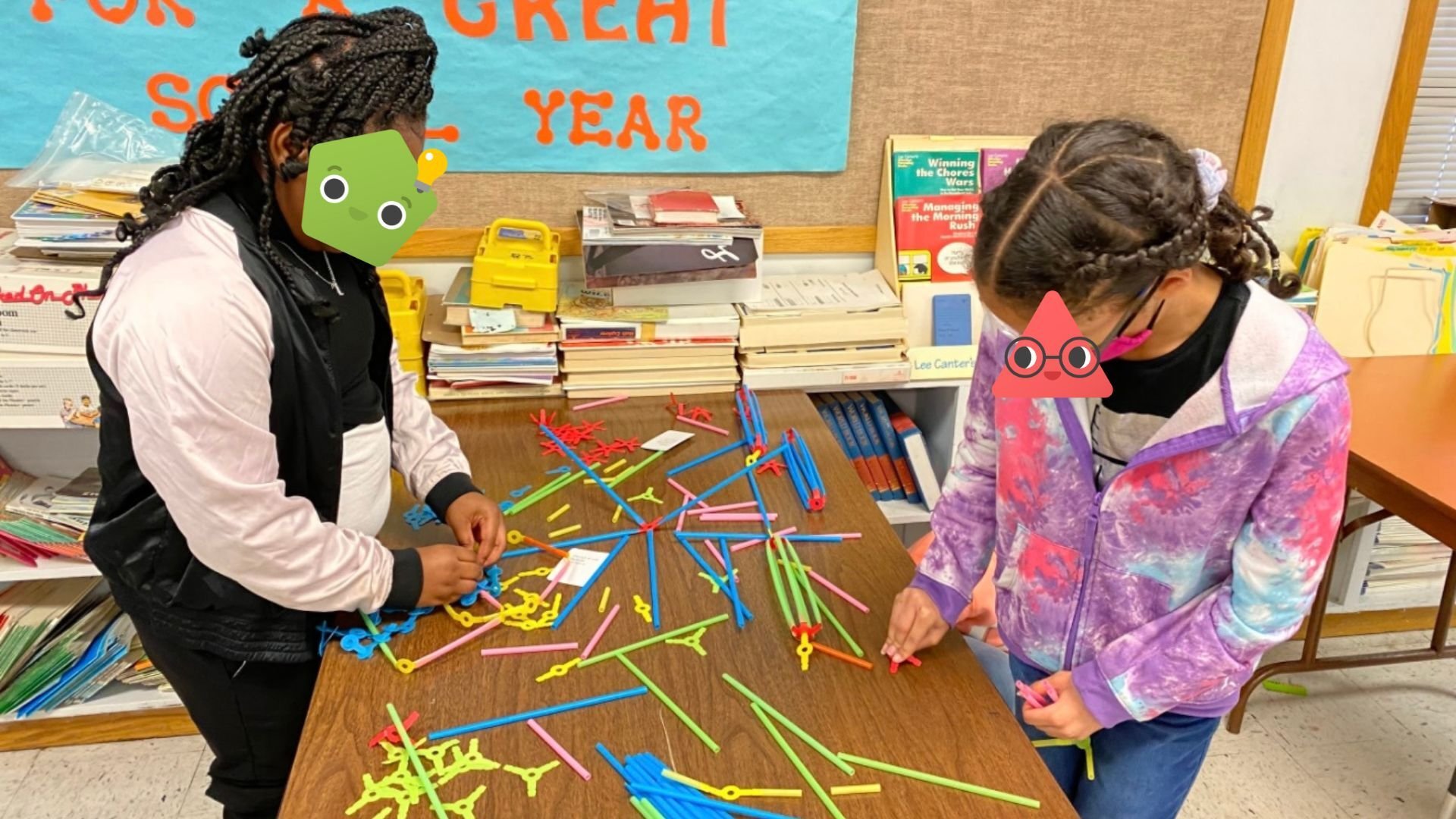 A group of students working with Strawbees.